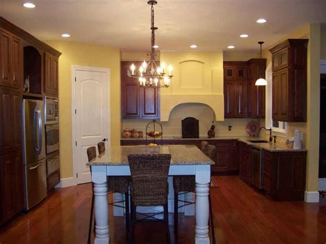 Kitchen opens up into living space and includes large central island with sink. Black Hardwood Flooring Choice