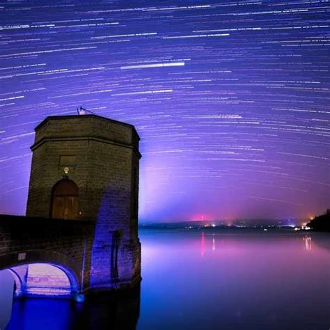 The Night Sky Is Filled With Star Trails And Stars In The Sky Above A