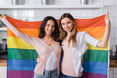 Cheerful Lesbian Couple Holding Lgbt Flag Free Stock Photo And Image