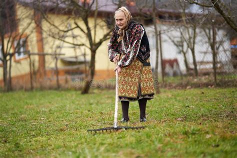 Old Farmer Woman Cleaning With A Rake Stock Photo Image Of Festival