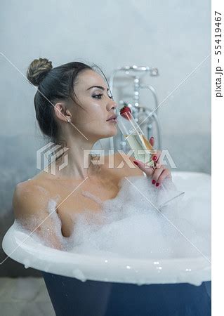 Woman Enjoying Champagne In Bathtub Pixta