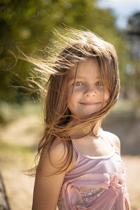 Cheerful Girl On Windy Day In Nature By Stocksy Contributor Pietro Karras Stocksy