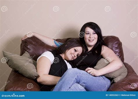 Two Girls Sitting On The Sofa Watching A Movie Stock Image Image Of
