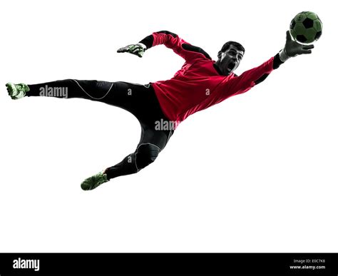 One Soccer Player Goalkeeper Man Catching Ball In Silhouette Stock