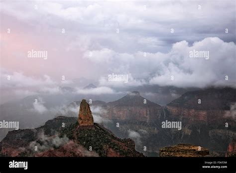 A Brief Hint Of Sunrise Reveals Mount Hayden Among The Rain Clouds And