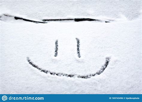 Snow Background Texture Of Wet Snow With A Cheerful Smiley Symbol