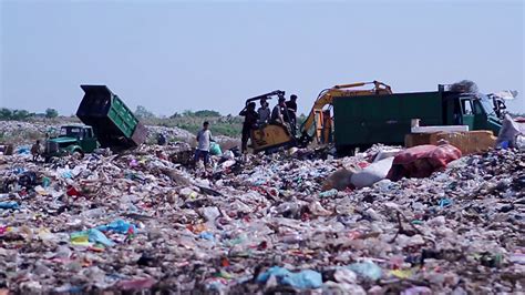 Workers At The City Dump Trucks Unload Garbage To The Dump Recycling