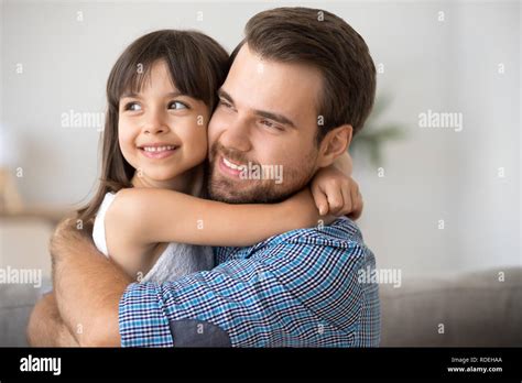 Hopeful Single Dad Embracing Kid Daughter Looking Into Bright Fu Stock