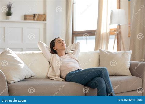 Relaxed Young Woman Rets On Sofa Enjoying Weekend Stock Image Image