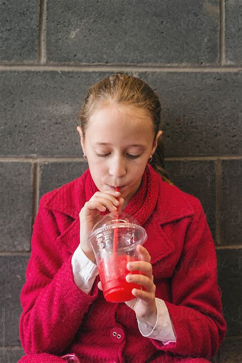 girl drinking red slushie drink del colaborador de stocksy gillian vann stocksy