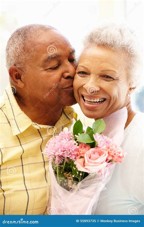 Senior Man Giving Flowers To Wife Stock Image Image Of Kissing Love