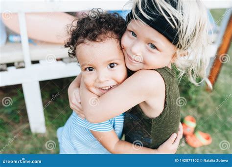 Dos Niños Pequeños Felices Se Abrazan Foto De Archivo Imagen De