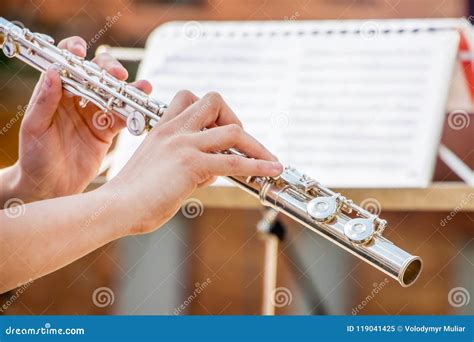 The Girl Plays The Flute Flute In The Hands Of The Musician During The