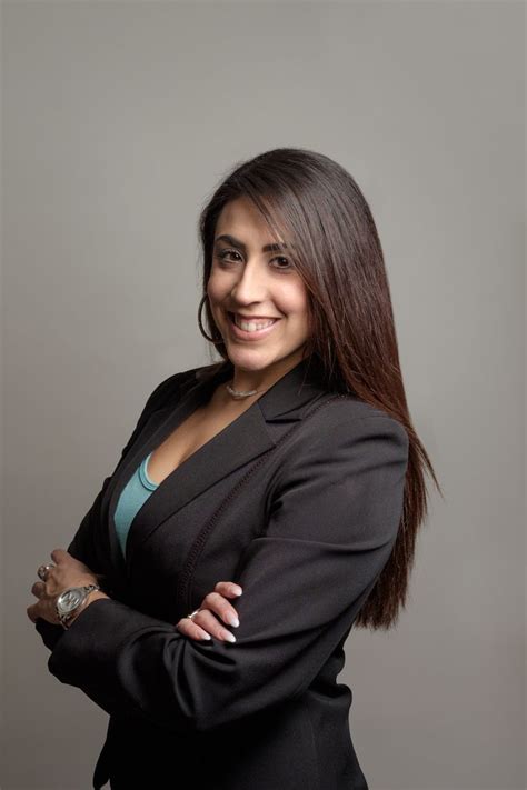 Business Headshot Of A Female Professional Looking At The Camera In