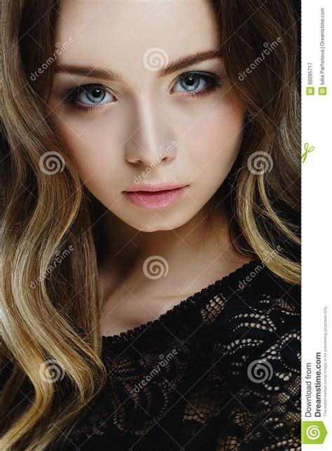 Beautiful Blond Girl With Big Blue Eyes On Black