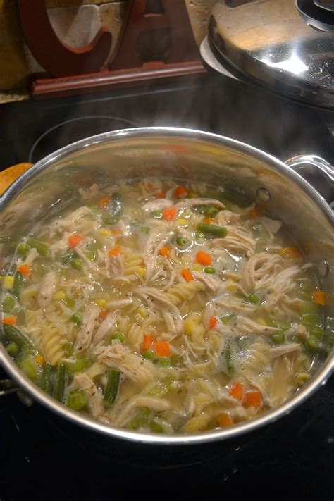 With a slotted spoon, remove chicken from broth. : Homemade Chicken Noodle Soup