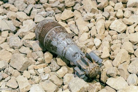 An Unexploded Mortar Mine Lying On The Rocks Clearance Of Unexploded