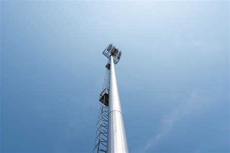 Free Photo Light Pole Tower In Sport Arena On Blue Sky