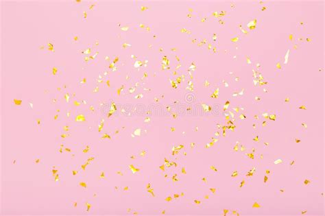 Golden Glitter Confetti Sparkles On Pastel Pink Background Flat Lay