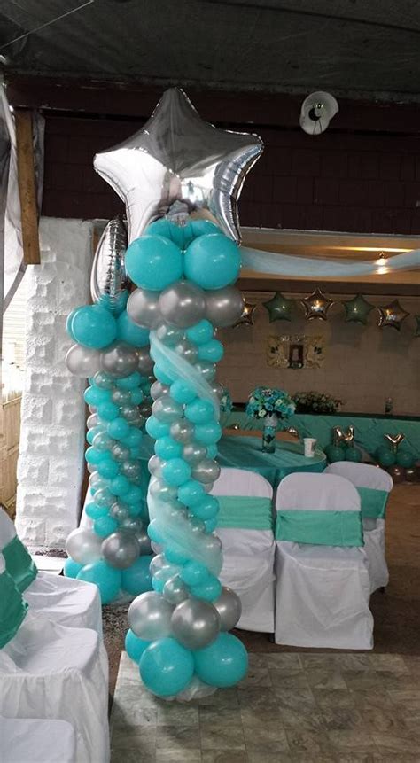 The Balloon Columns Are Decorated With Blue And Silver Balloons White