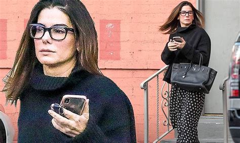 Sandra Bullock Stays Warm In Black Mock Neck Sweater And Long Patterned