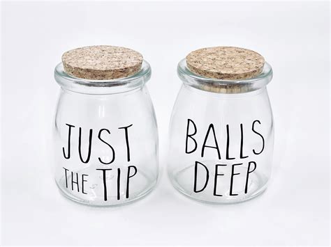 Two Glass Jars With Cork Lids That Say Just The Tip And Balls Deep
