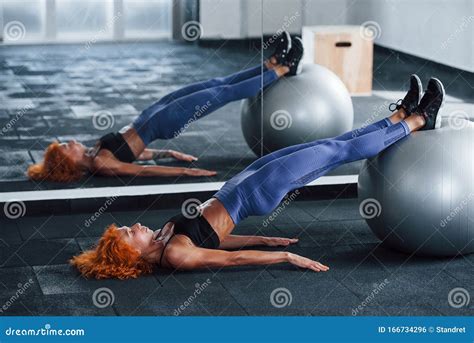 Using Silver Colored Exercise Ball Sporty Redhead Girl Have Fitness
