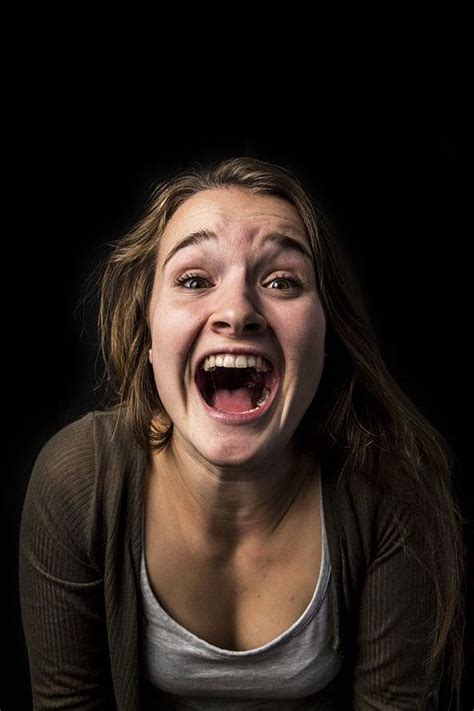 A Woman With Her Mouth Open And An Angry Look On Her Face In Front Of