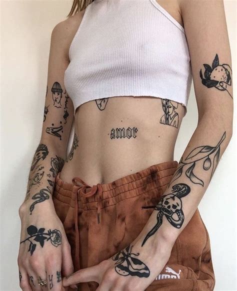 A Woman With Many Tattoos On Her Arms