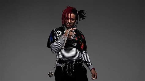 Smiling Trippie Redd With Braided Hair Is Wearing Black White Designed