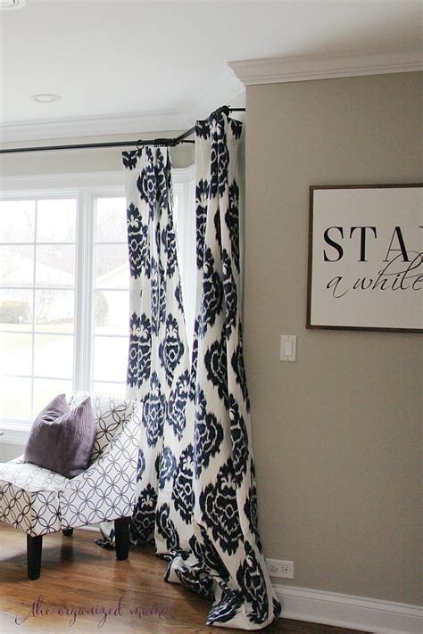 How To Hang Bay Window Curtains On An Oversized Window The Organized Mama