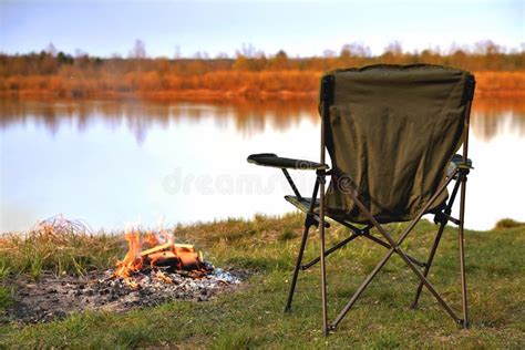 Tourist Chair Folding Chair Bonfire On The River Bank In Autumn At