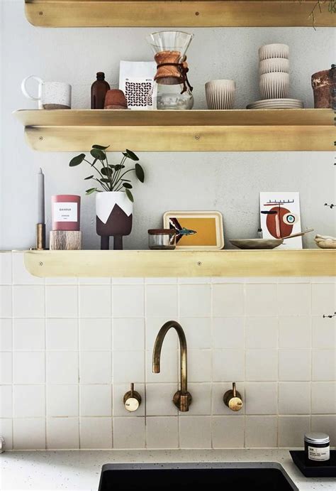 Brass Shelves With Rounded Corners Do Double Time As Decorative Element