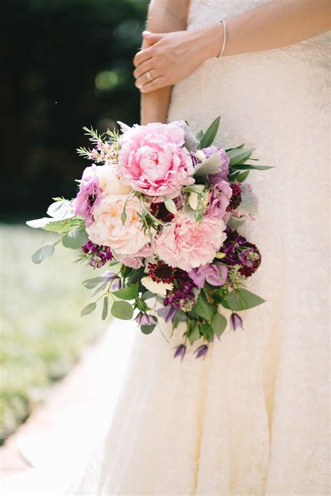 loose cascading bridal bouquet of light pink peony ocean song rose dark purple stock dried