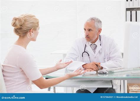 Patient Consulting A Serious Doctor Stock Image Image Of Indoors