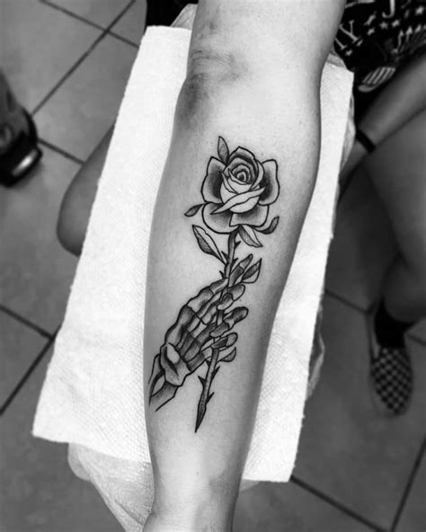 Hand Holding Rose Tattoo