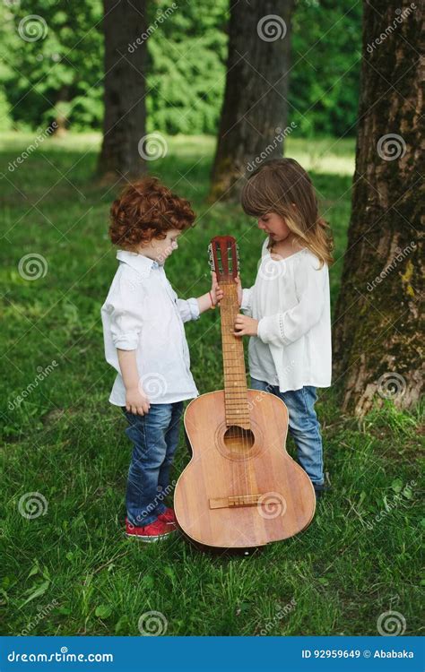 Cute Little Children Playing Guitar Stock Image Image Of Light Park