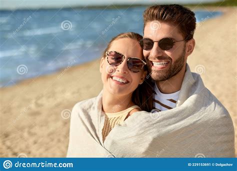 Happy Couple Covered With Blanket Hugging On Beach Stock Image Image Of Love Romantic 229153691