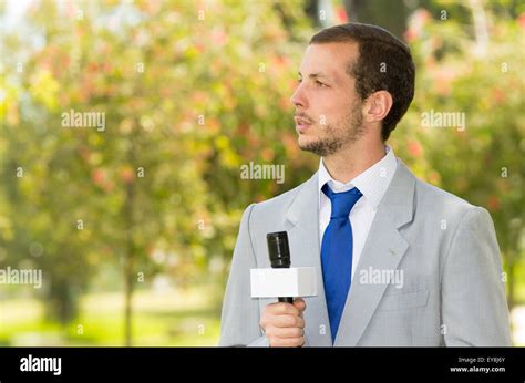 Successful Handsome Male News Reporter Wearing Light Grey Suit Working