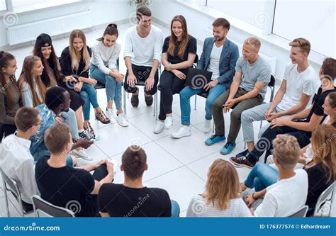 Large Group Of Diverse Young People Sitting In A Circle Stock Photo