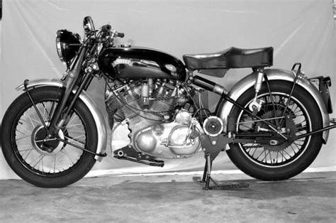 Black And White Photograph Of A Motorcycle On Display In Front Of A