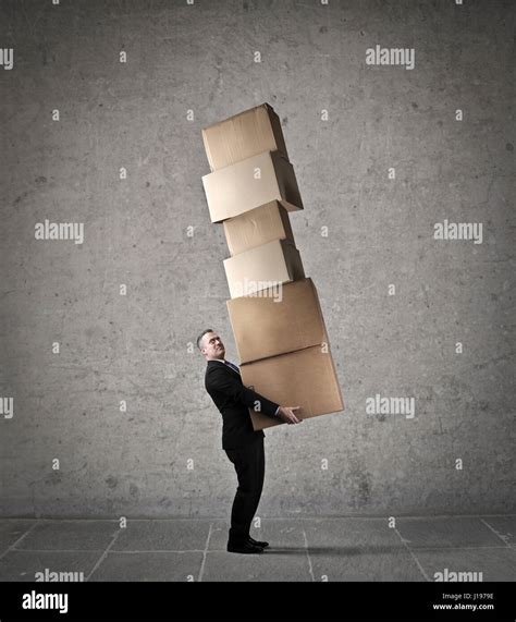 Businessman Carrying Heavy Boxes Stock Photo Alamy