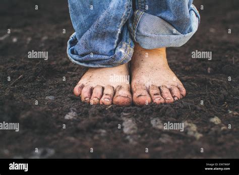 Close Up Of A Boys Dirty Feet Standing In Soil Stock Photo Alamy
