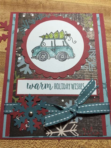 A Handmade Christmas Card With A Blue Car And Snowflakes On The Side