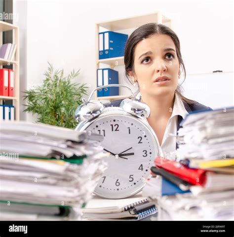 Female Employee With Too Much Work In The Office Stock Photo Alamy