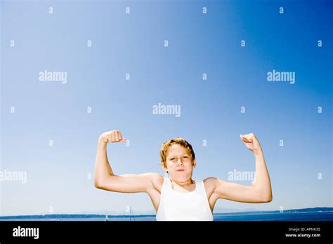 Young Boy Flexing His Muscles Stock Photo Alamy