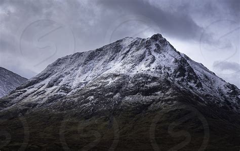 Snowcapped Mountain Peak In Scottish Highlands During Season Change