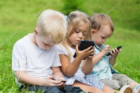 Happy Children Using Smartphones — Stock Photo © Stask 62337147