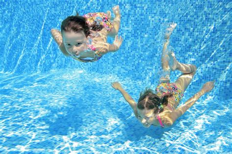 Premium Photo Children Swim In Pool Underwater Happy Active Girls