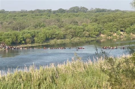 video shows massive group of migrants crossing texas border